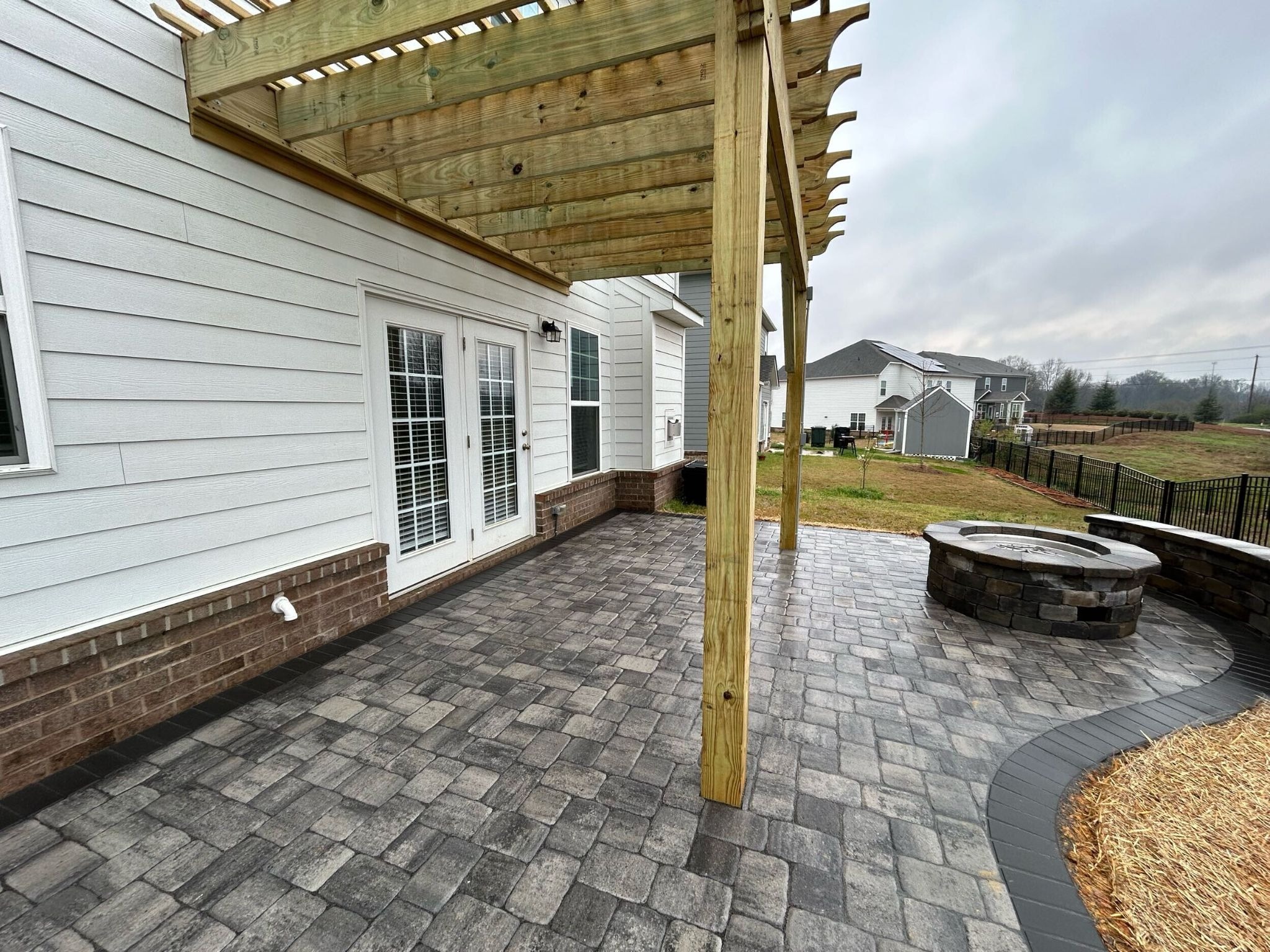 Custom paver patio, fire pit, and pergola in Indian Trail, NC.